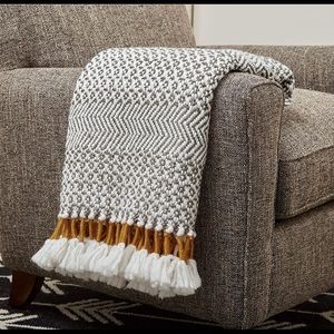 New in package! Rivet Throw . Grey/white with Mustard Yellow accents